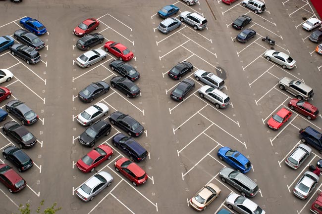 Aerial view of a parking lot with many cars parked